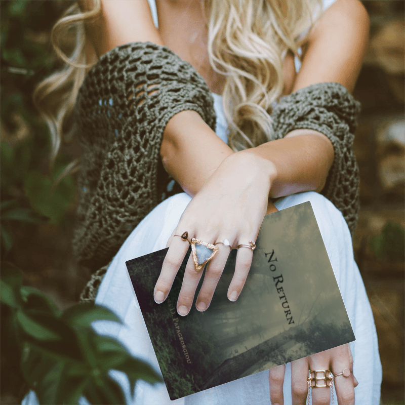 Woman with blonde hair and a green knit shawl holding the book "No Return"