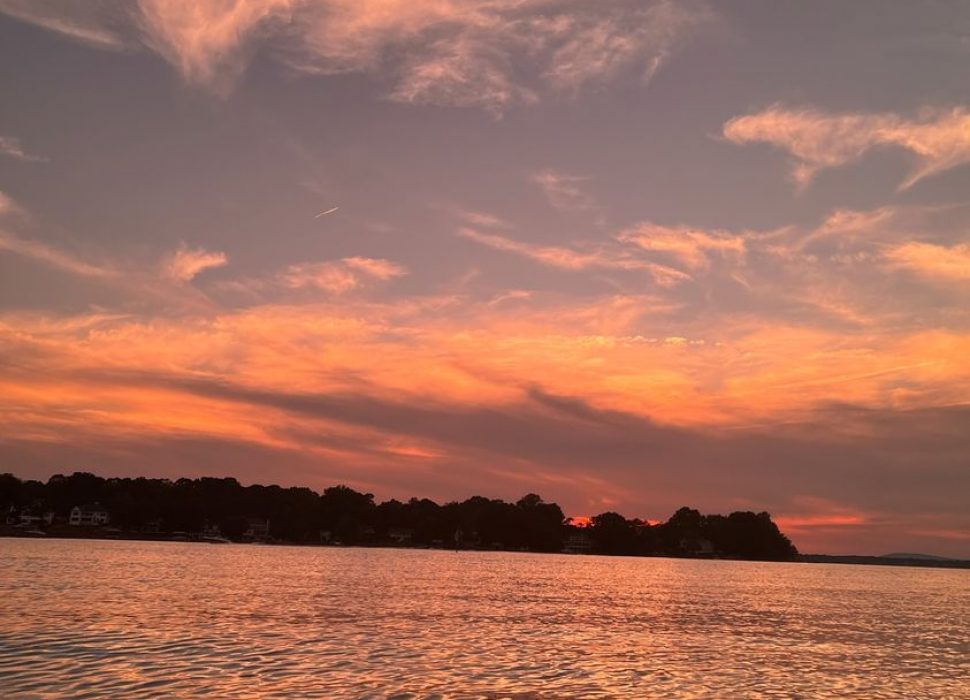 Picture of an orange and red sunset over water.