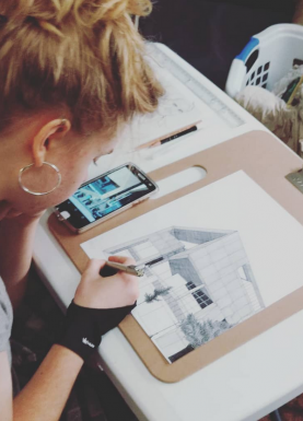 Photo of Elleina drawing a building