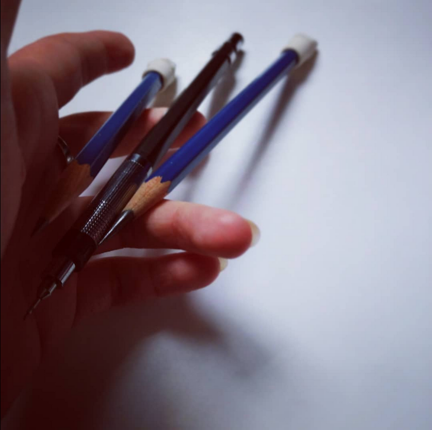 hand holding pencils