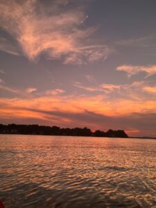 Picture of an orange and red sunset over water.